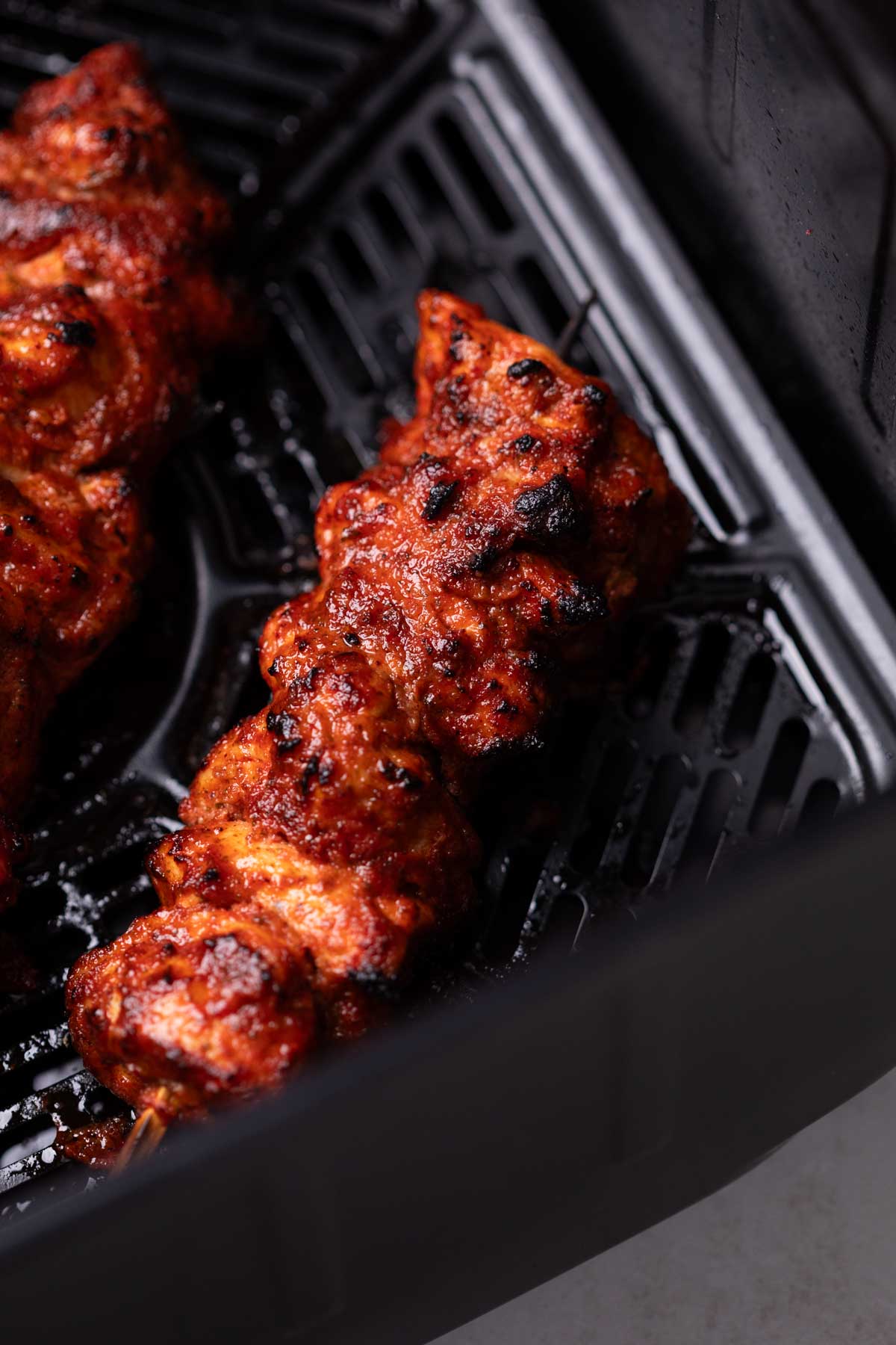 an image of air fryer chicken tikka in an air fryer basket