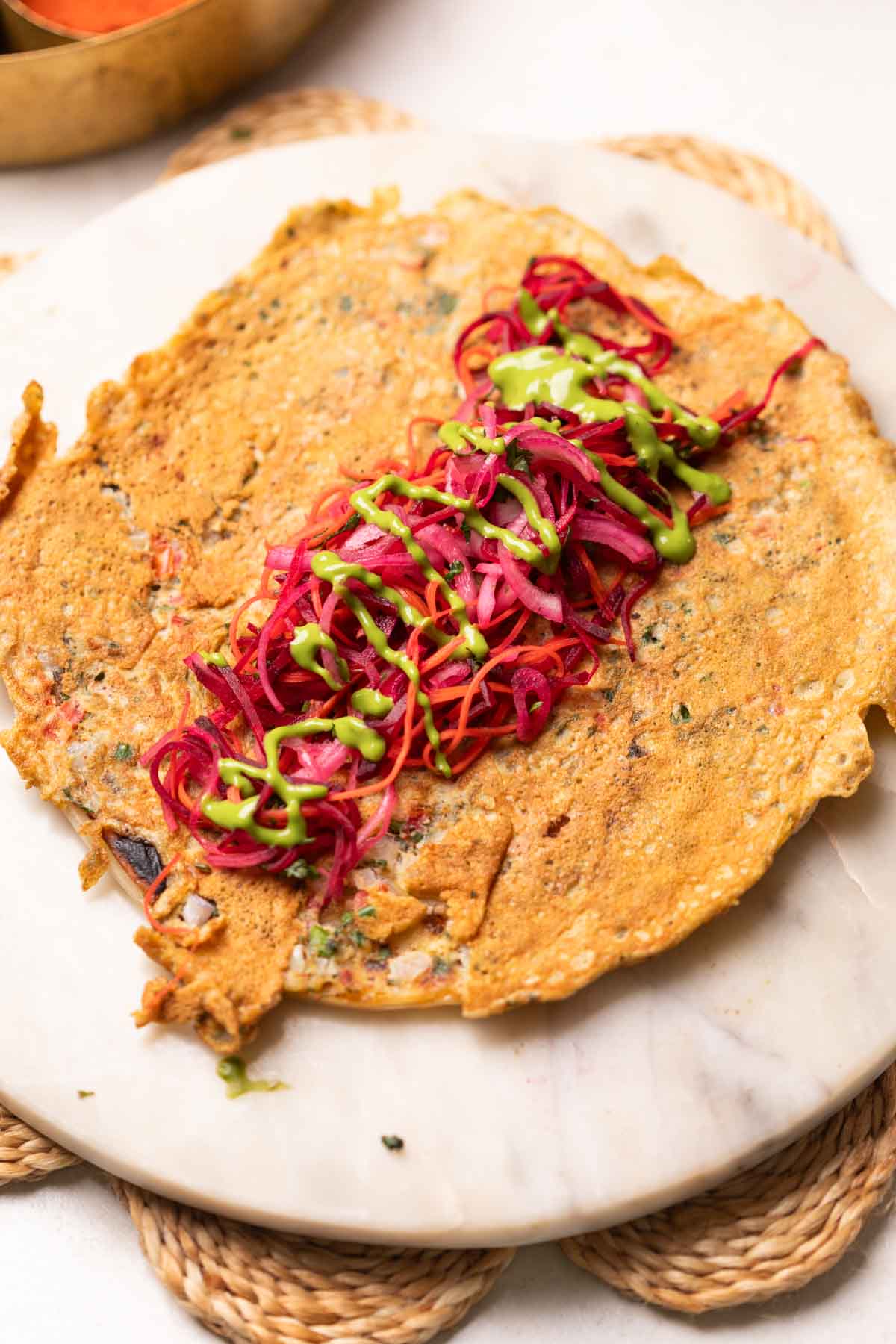a flatlay image of anda paratha with filling in the middle