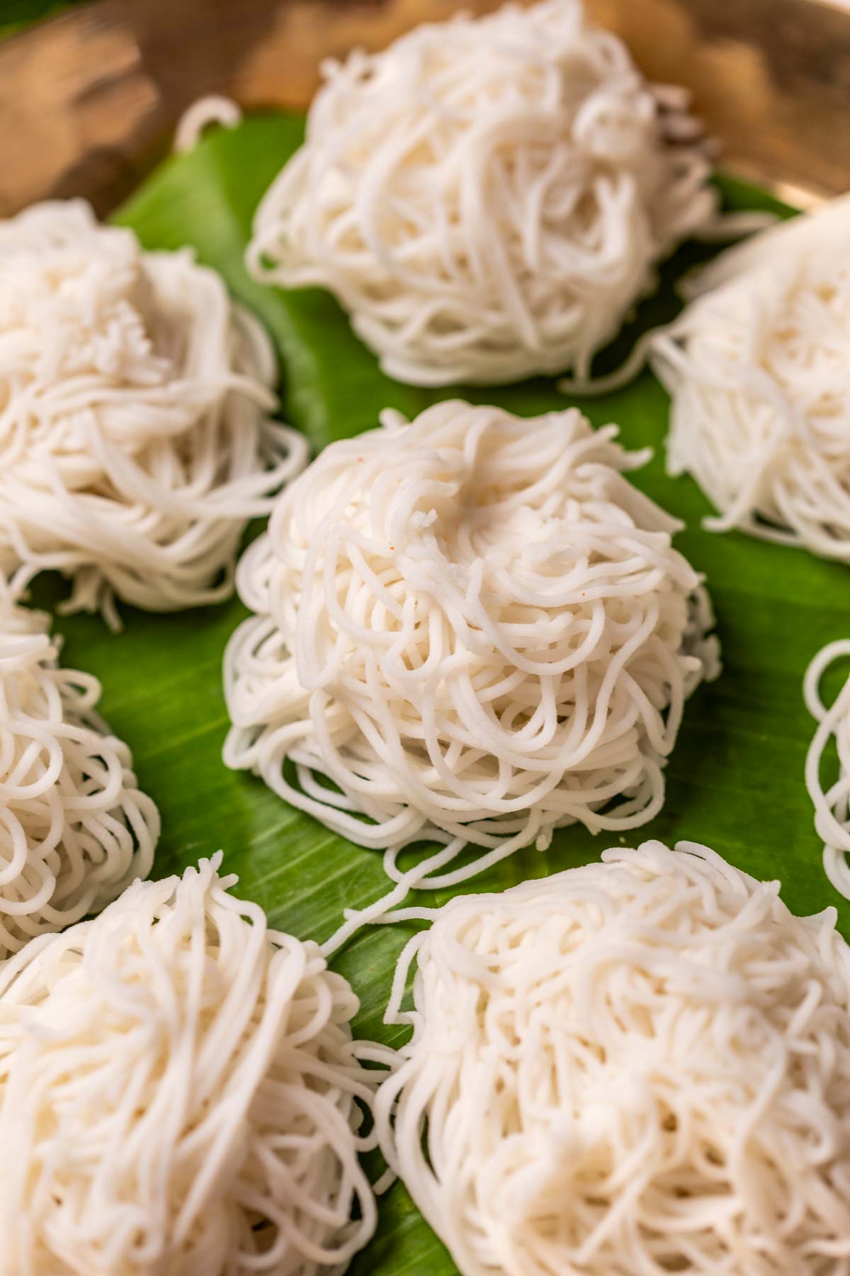 Rice idiyappams served on banana leaf in a plate