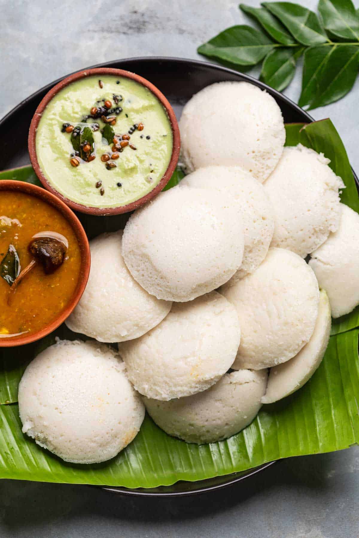 soft and fluffy idlis served with chutney and sambar