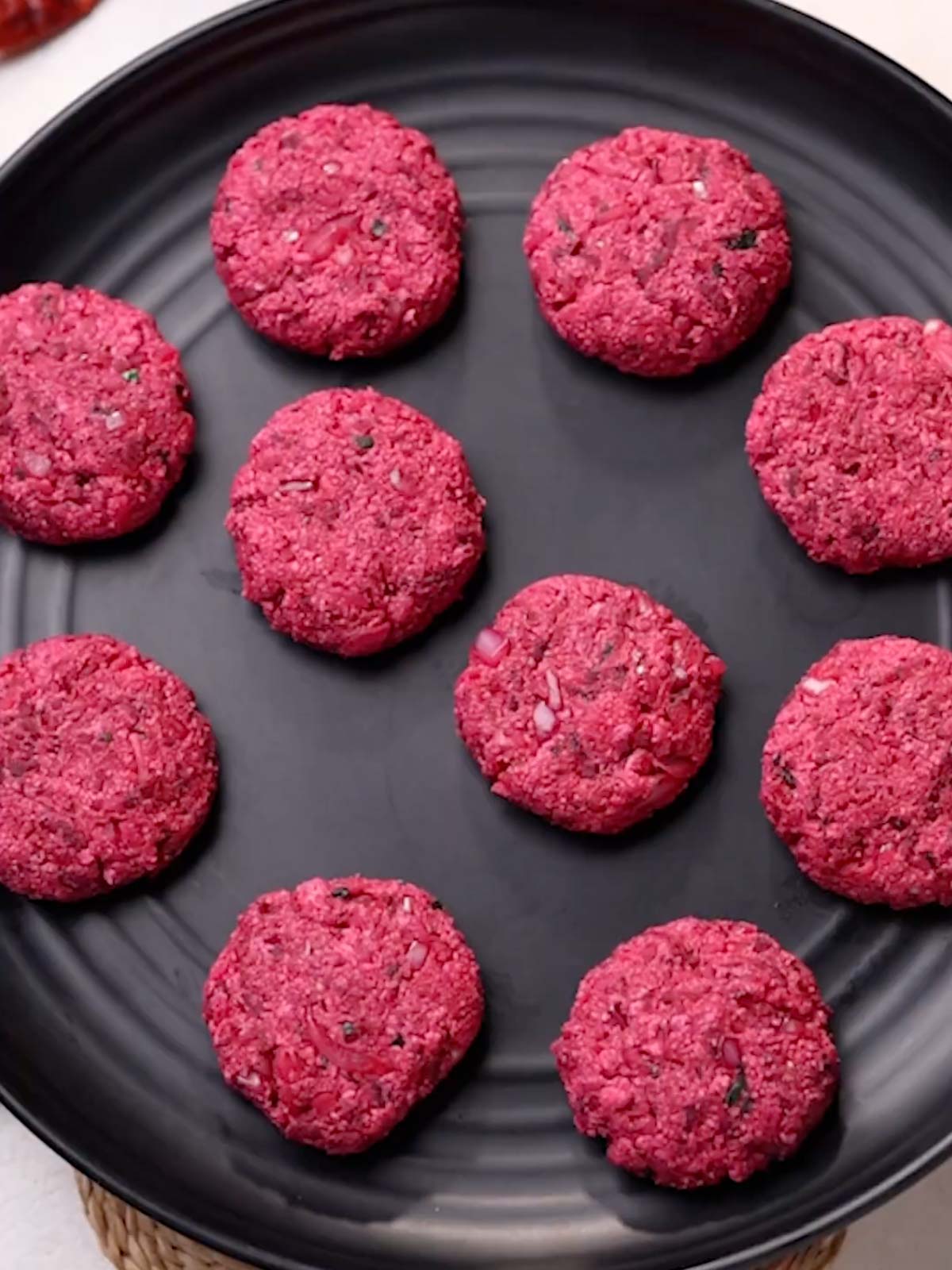 beetroot tikkis placed on a round black platter