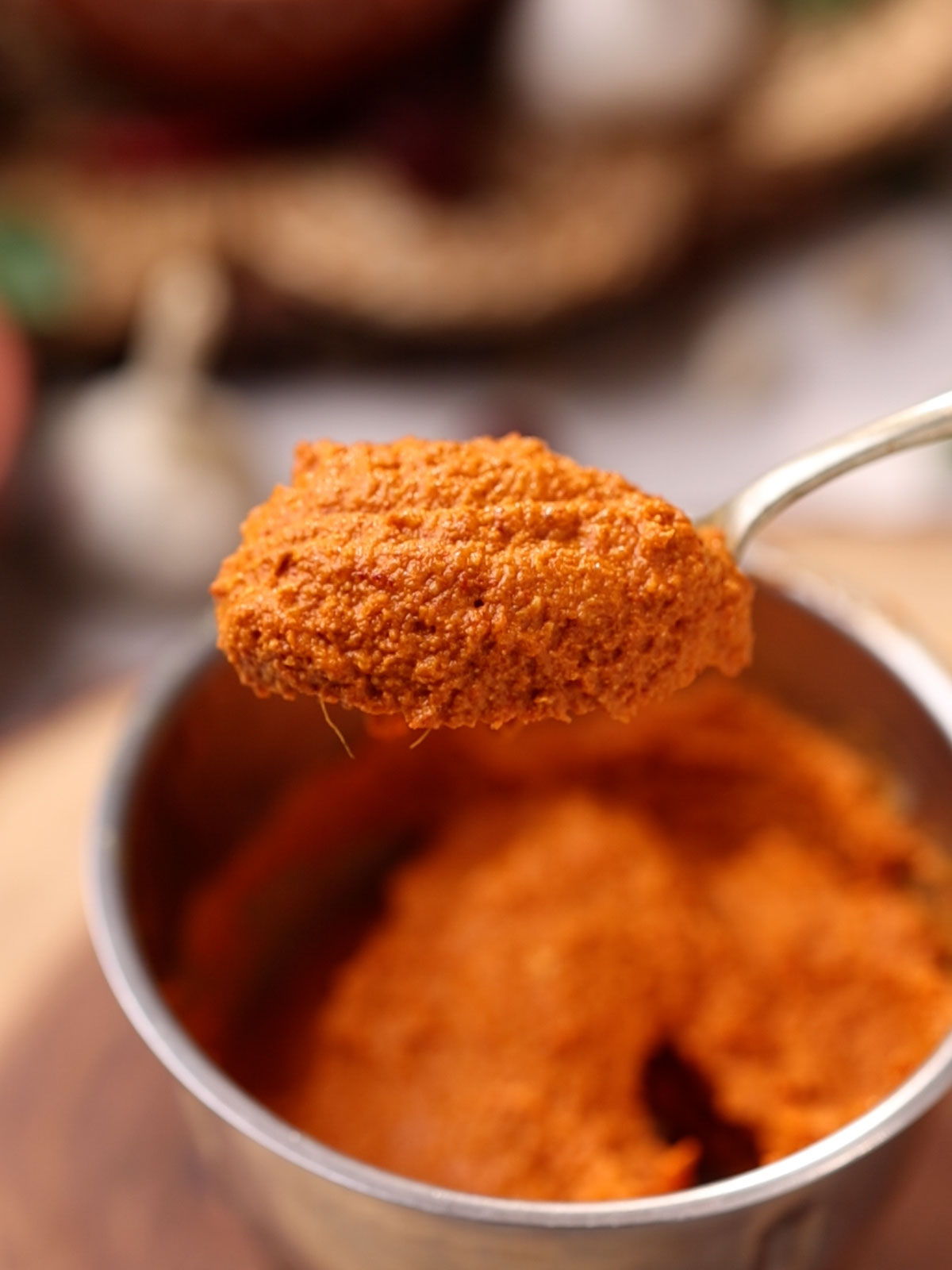 A spoonful of the red chutney that goes on mysore masala dosa to show the colour and texture