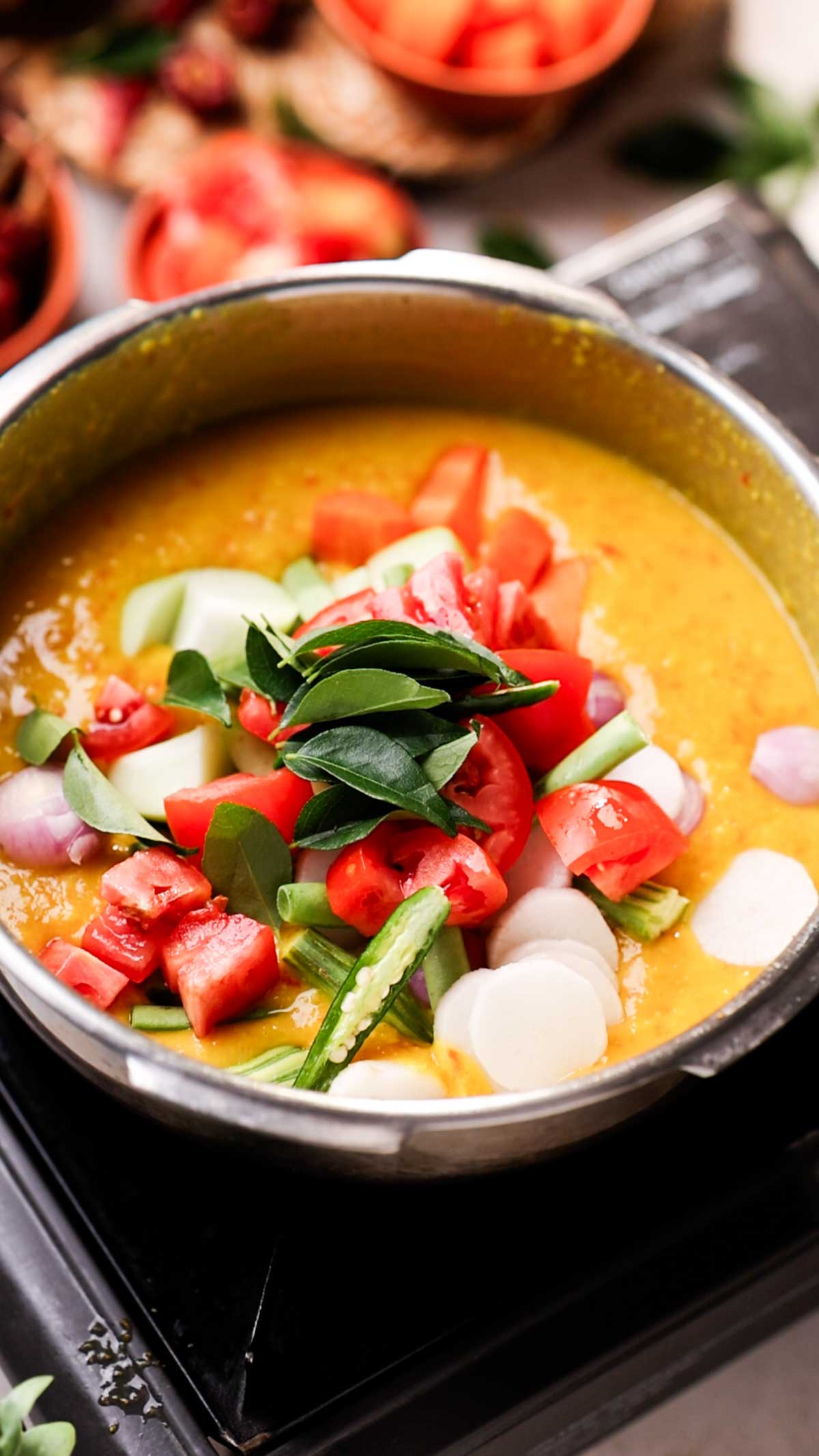 veggies over cooked dal ready to be cooked to make one pot sambar