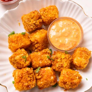 air fryer paneer popcorn served on a white plate with accompaniments