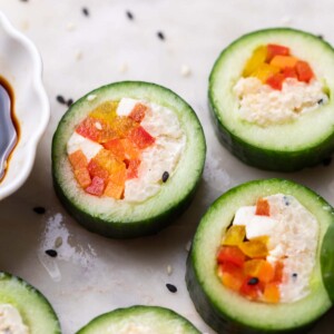 close up of cucumber sushi served with soy sauce
