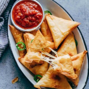 Super cheesy jalapeno three cheese samosa are sure to become a favourite because who can resist gooey stringy cheese stuffed in crispy samosa wrappers! These vegetarian samosas have a filling of mozzarella, cream cheese, smoked cheddar and jalapenos and folding them is really easy too.&nbsp;