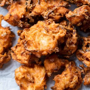 Closeup of onion pakodas served on a board