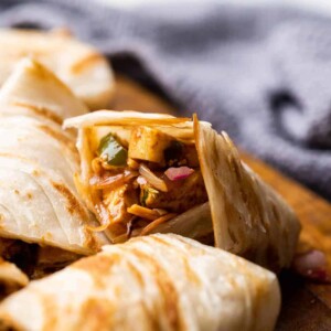Paneer kathi roll cut into pieces and stacked on top of the other