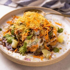 Bread Chaat served on a white plate with a spoon on the side