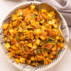 Corn Bhel served in a cowl with a spoon on the side