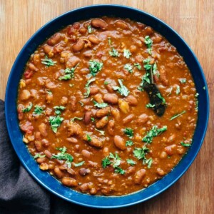 Rajma Masala served in a blue bowl with chopped coriander sprinkled over