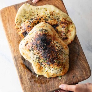 garlic thecha naan on a wooden board