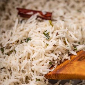 a close up image of jeera rice to show it's fluffy texture