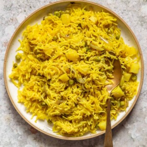 picture of tahari rice in a white plate with a steel spoon