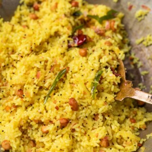 Raw mango rice in a kadai with a ladle