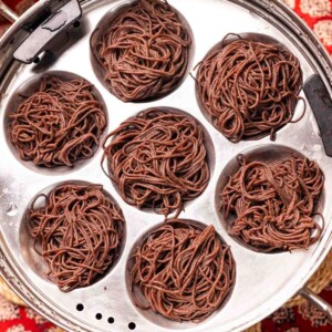 freshly steamed ragi idiyappams placed in a in steamer