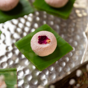 rose kacha golla garnished with dried rose petal and served on a leaf square