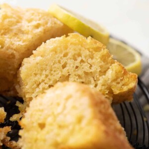 A slice of eggless lemon cake to show the light airy texture of the cake