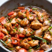 close up of black pepper chicken being cooked in a pan