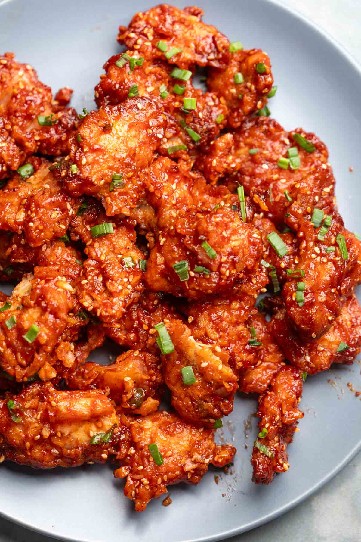 crispy glossy, sticky honey garlic chicken served on a plate