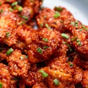 close up of honey garlic chicken to show it's crispy texture and glossy, sticky finish