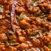 close up shot of chettinad chicken curry to showcase it's texture and color