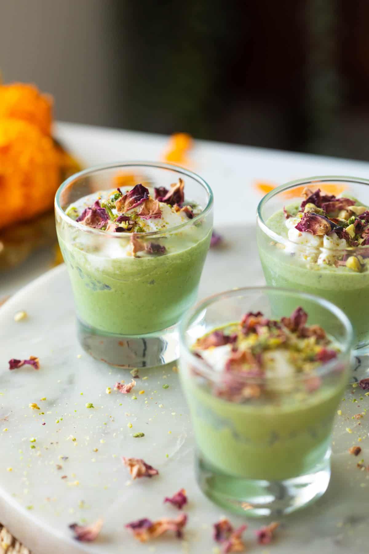 a close up image of paan falooda shots served on a white platter