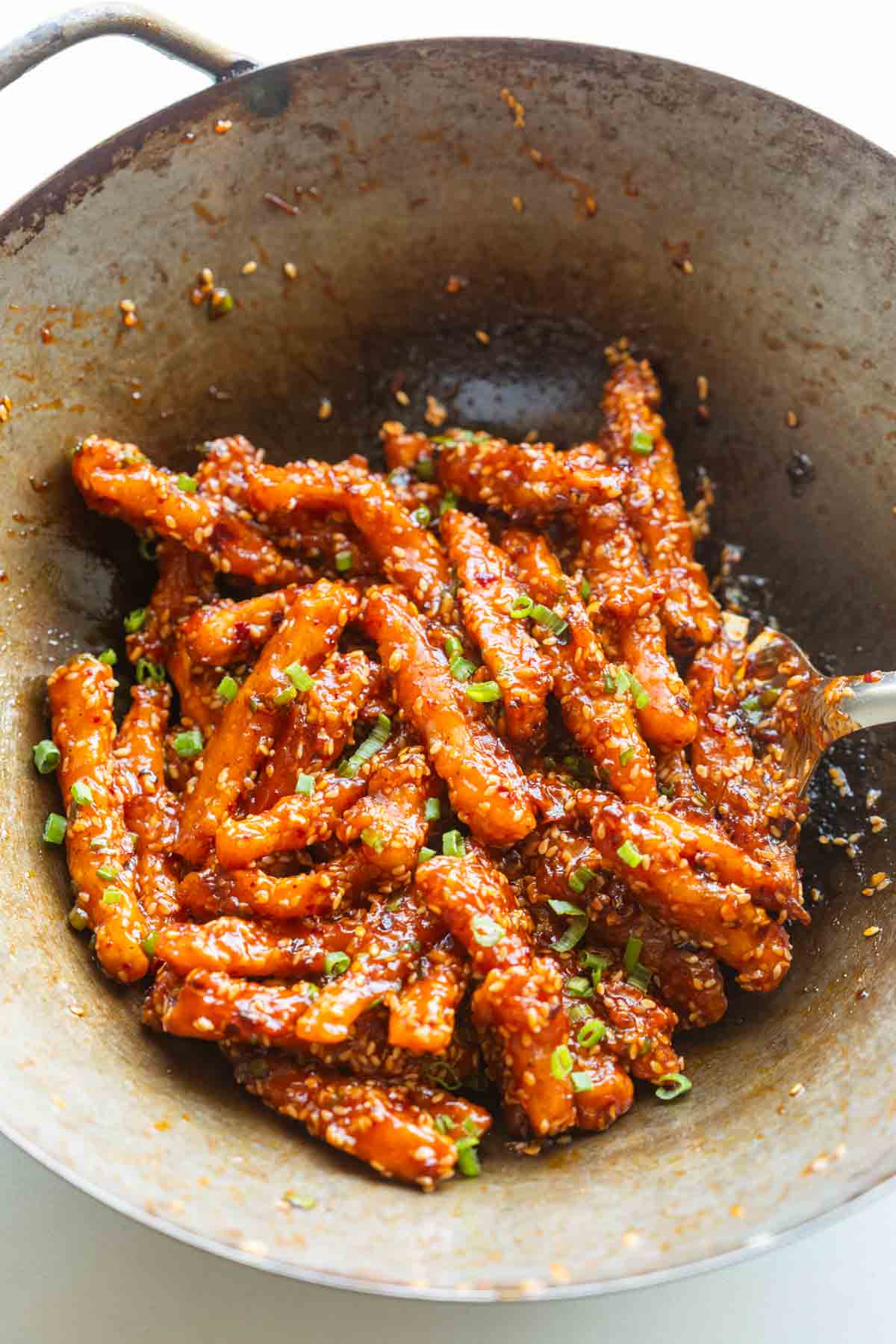 crispy honey chilli potatoes in a wok straight from the stove