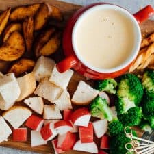 Easy cheese fondue recipe with white wine picture with fondue dippers such as bread, broccoli, wedges, radishes, bread sticks etc.