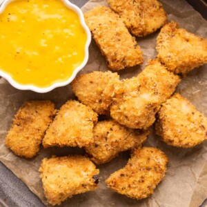 Chicken Nuggets served on a plate with a mango mustard dipping sauce