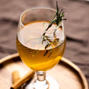 Hot toddy served in a short stemmed glass on a brown plate