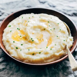 Mashed potatoes flavored with garlic and served in a wooden bowl.