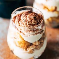 Baileys Tiramisu seasoned with coffee powder and served in a glass.