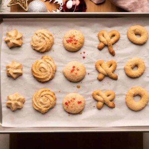 Two hands holding an entire tray of danish brown butter cookies