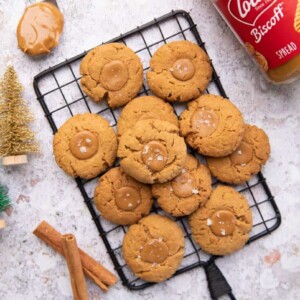 A shot of biscoff cookies stacked one one top of another on a black grill tray.
