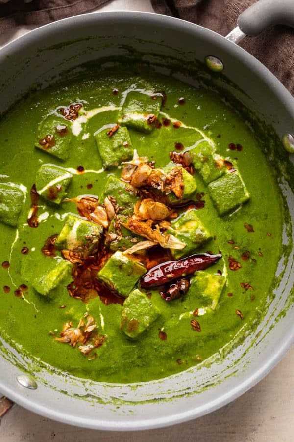 Palak paneer pictures in the pan that it was cooked in with garlic tadka on top