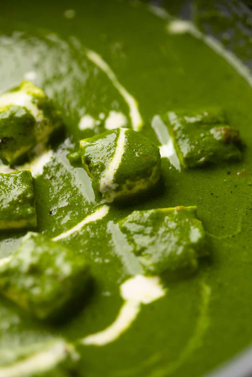 Closeup of the palak paneer gravy to show the luxurious, rich curry base