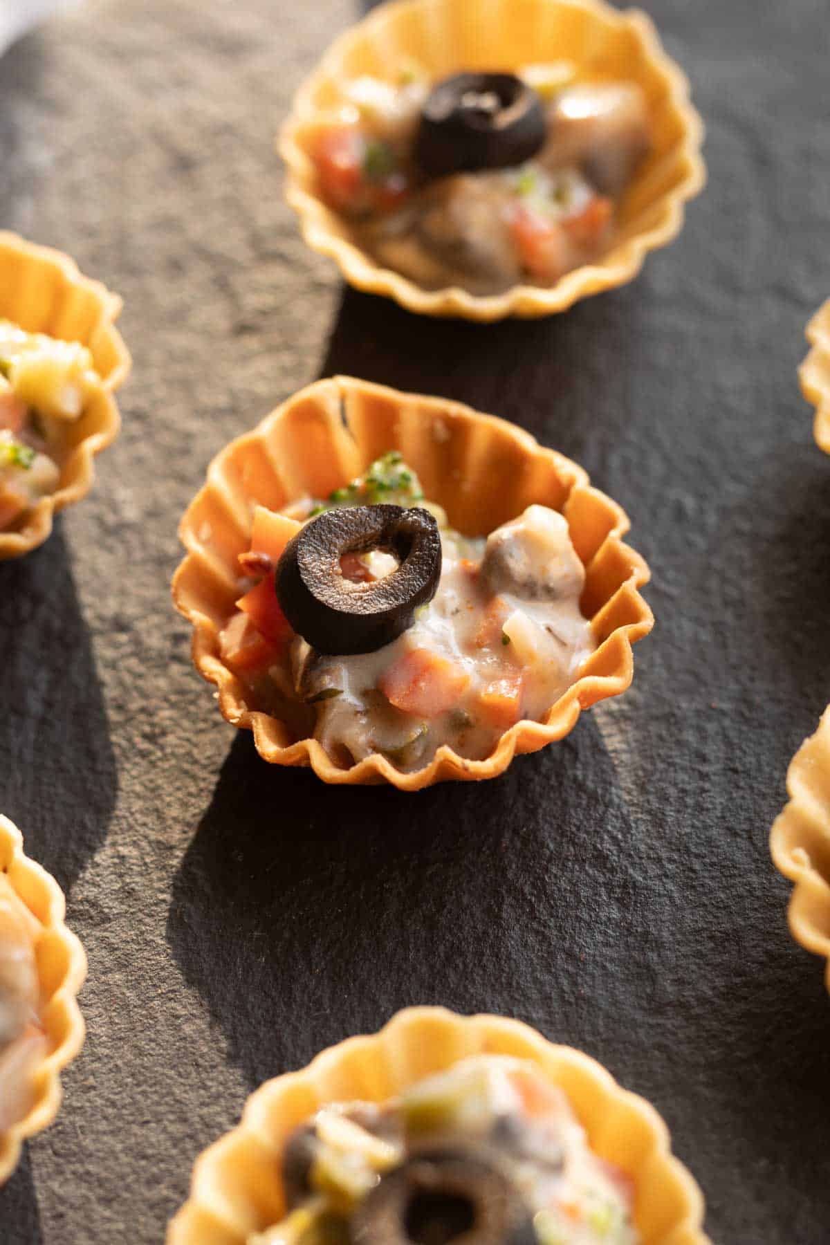 veg canapes sered on a black board ready to be eaten 