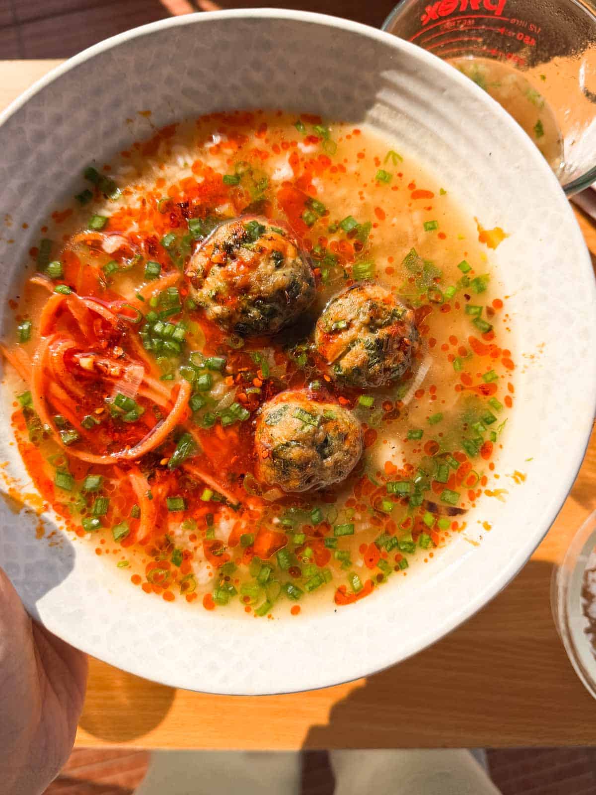 air fryer chicken meatballs in ginger broth served in a white bowl