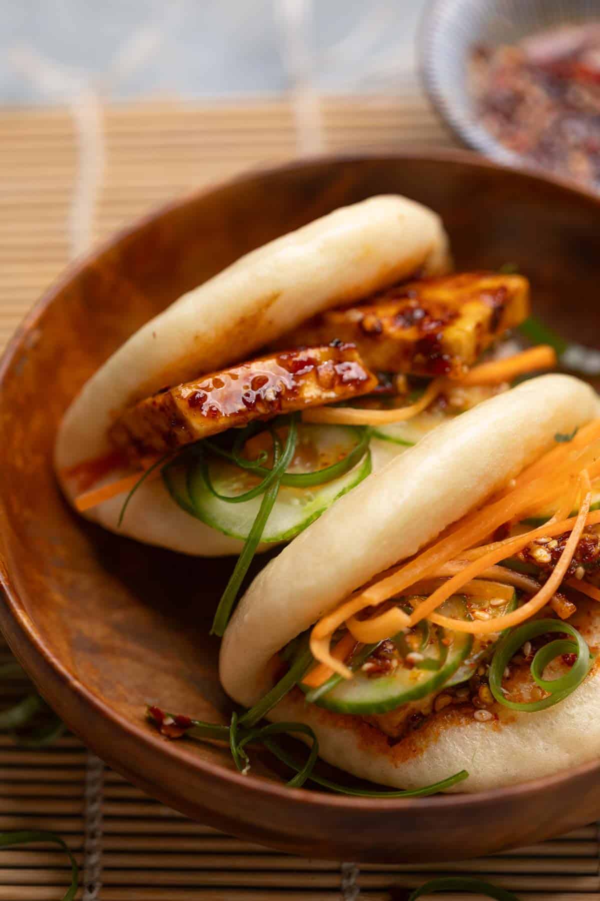 close up image of steamed bao buns served with paneer filling