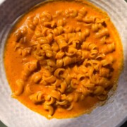 red pepper pasta served in a white bowl