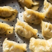 freshly steamed chicken momos placed in the steamer