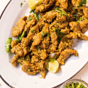 chicken majestic served on a white platter with accompaniments