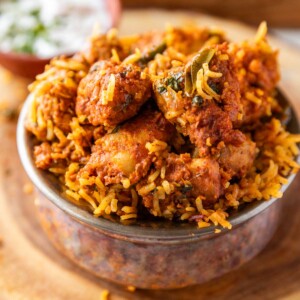 boneless chicken biryani served in a copper handi style bowl