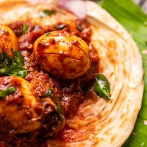 close up image of Kerala egg roast served on Malabar Parotta