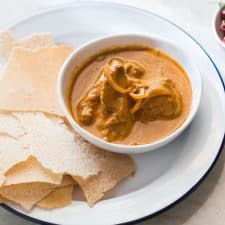 Chicken Kori Rotti served in a white plate.
