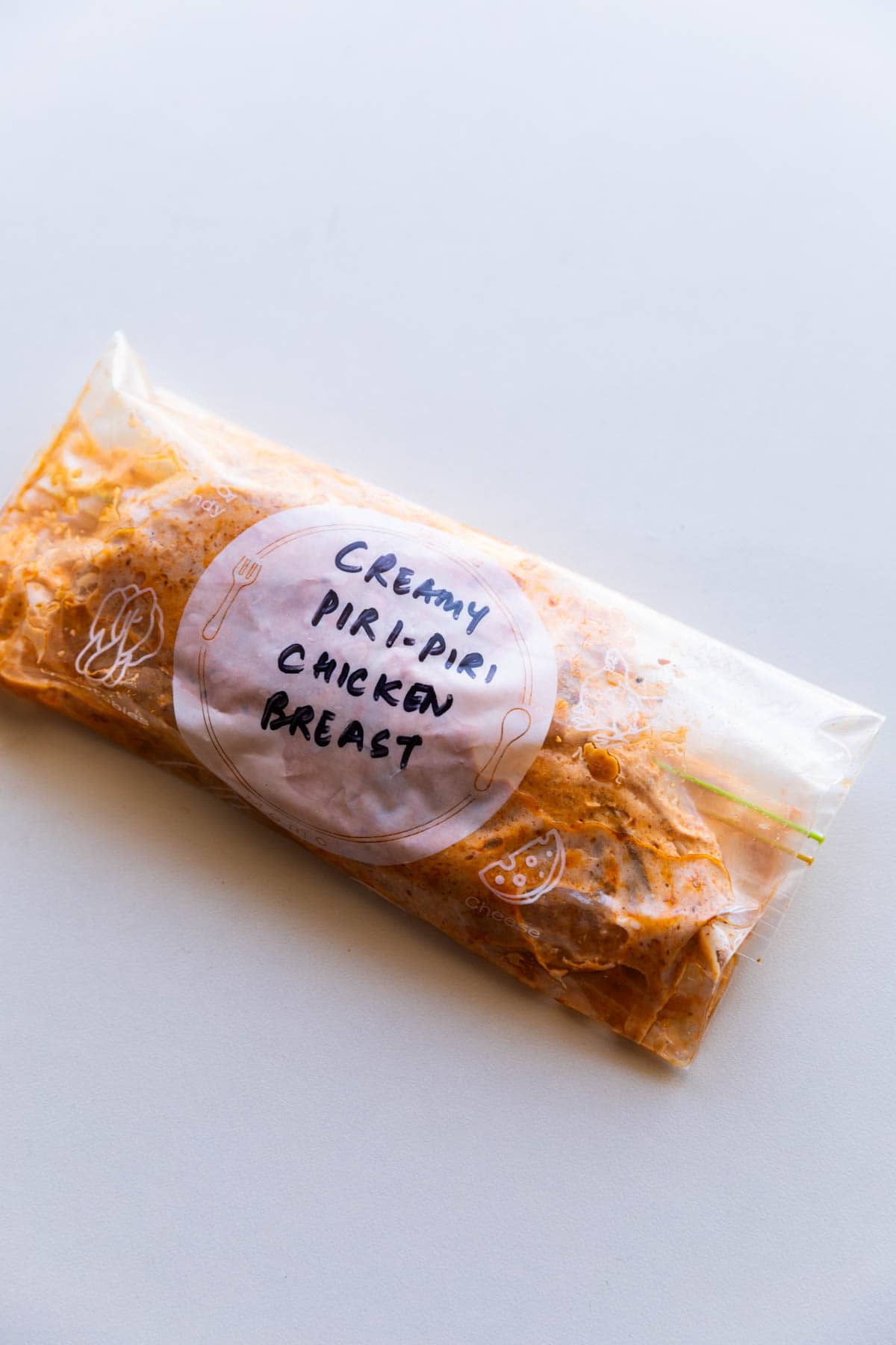 chicken breast marinated in piri piri marinade and stored in a labelled zip lock bag