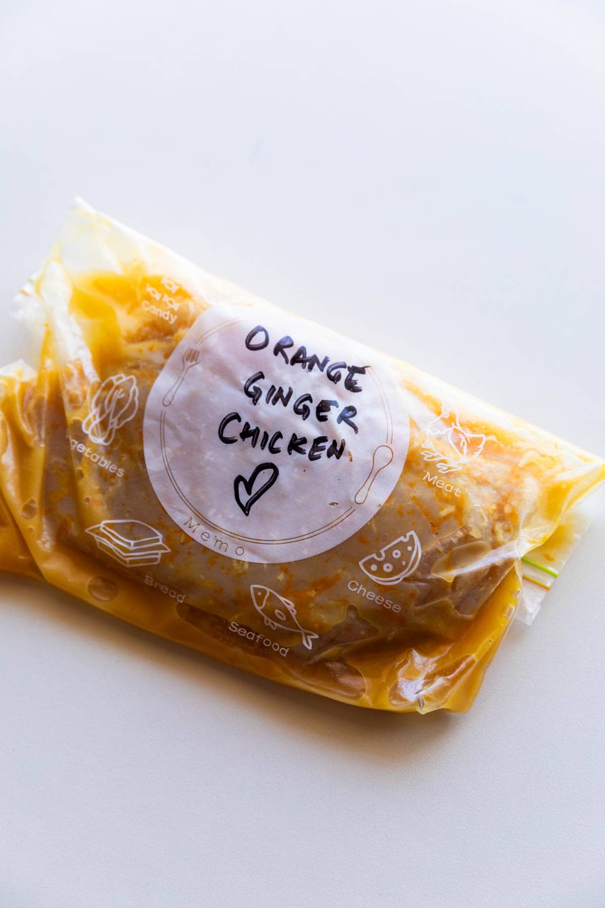 chicken breast marinated in orange ginger marinade and stored in a labelled zip lock bag