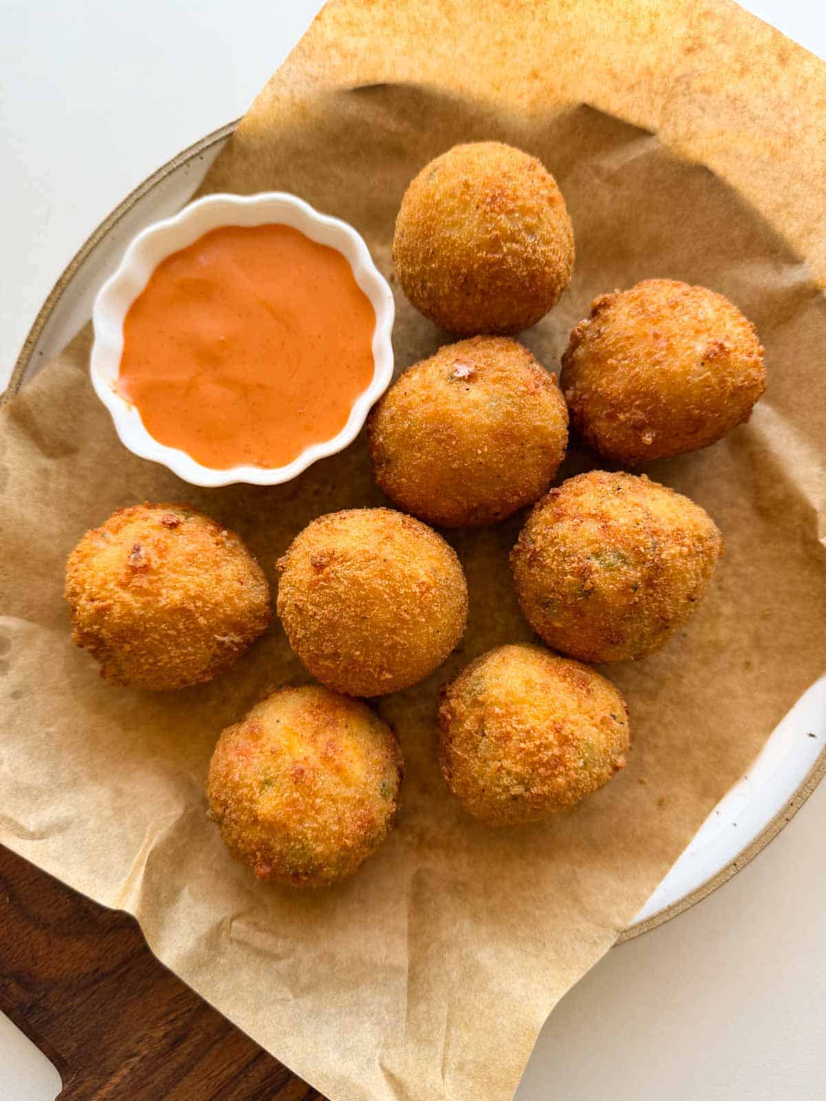cheese balls served on a platter with a dip