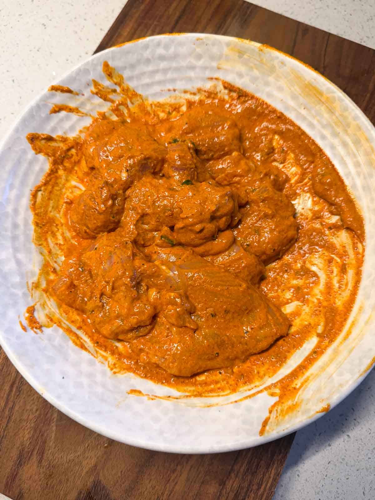 bone-in chicken leg pieces pieces marinated in a yogurt-spice marinade of iffa chicken